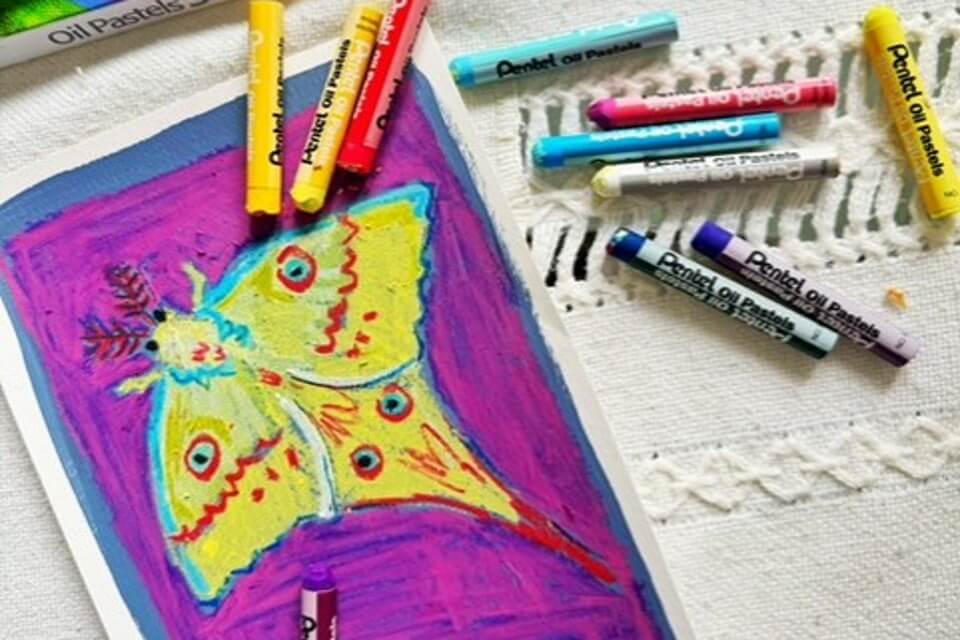 A photograph of brightly coloured, oil pastels study, with oil pastels scattered around it